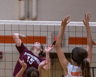 DIANNA OATRIDGE | THE VINDICATOR Boardman's Kaylin Burkey (15) attempts a kill as Howland's Mia Pantalone (left) and Maddie Sisler (right) prepare to block during their match in Howland on Tuesday. The Spartans won 3-0.