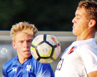 Howland’s Gabe Altawil (33) directs the ball off his chest against Poland’s Mason Matiste during an All-American Conference soccer match Tuesday night.
