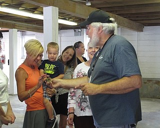 Neighbors | Jessica Harker.Bill Gilmour held a chick he allowed guests to pet at the Family Tour event on Aug. 2 at the MetroParks Farms.