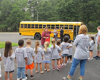 Neighbors | Jessica Harker.On Board Instructor Lauri Woolley told children about proper bus safety during the annual Safety Village event on Aug. 9.