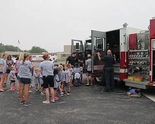 Neighbors | Jessica Harker.Fire fighters let children sit in the fire truck on Aug. 9 for the annual Safety Village event at Glenwood Junior High School.