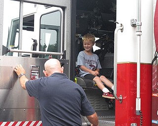 Neighbors | Jessica Harker.Fire fighters let children sit in the fire truck on Aug. 9 for the annual Safety Village event.