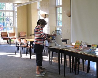 Neighbors | Jessica Harker.Cathy Desimone chose a coloring page during the August 10 Color Your World event at the Poland library.