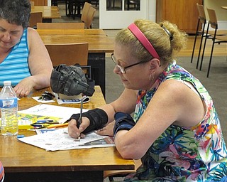 Neighbors | Jessica Harker.Sue Moderalli colored her page during the August 10 Color Your World event at the Poland library.