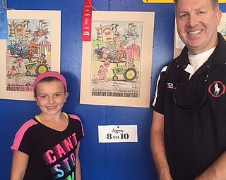 Neighbors | Submitted.Maddie and her father Gregory Facemyer standing next to Maddies winning photo at the Canfield Fair.