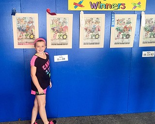 Neighbors | Submitted.Maddie Facemyer standing next to her second place drawing.