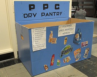 Neighbors | Jessica Harker.A box listing the donations needed for the paper goods pantry sits outside the door for anyone who is interested in donating.