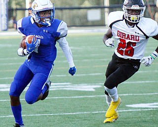 William D. Lewis The Vindicator  Hubbard's JayQuab Odem(1) eludes Girard's Robert Dolwick(26) during 8/31/18 action at Hubbard.