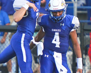 William D. Lewis The Vindicator Hubbard QB Davion Daniels(4) gts congrats from Cam Resatar(7) after scoring in 1rst qtr against Girard at Hubbard.
