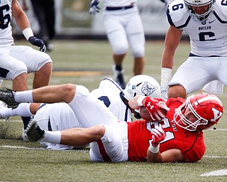 YSU's Ryan Emans holds onto the ball during the first half of their opening game against Butler on Saturday.