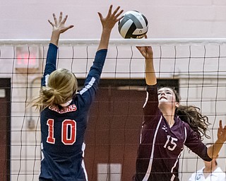 DIANNA OATRIDGE | THE VINDICATOR Boardman's Kaylin Burkey, tips the ball as Austintown Fitch's Emma Bartlett attempts to block during their AAC match in Boardman on Tuesday. The Spartans rallied to win 3-2.