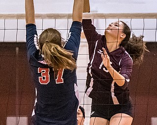 DIANNA OATRIDGE | THE VINDICATOR Boardman's Kaylin Burkey, attempts a kill as Austintown Fitch's Cate Maguire goes up for the block during their AAC match in Boardman on Tuesday. The Spartans rallied to win 3-2.