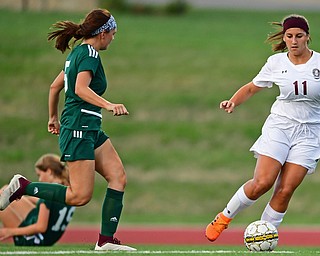 YOUNGSTOWN, OHIO - SEPTEMBER 5, 2018: Boardman's Lilly Essad dribbles away from Ursuline's Kenzie Larch and Megan Wilson during the second half of their game on Wednesday night at the Youngstown State soccer complex. DAVID DERMER | THE VINDICATOR