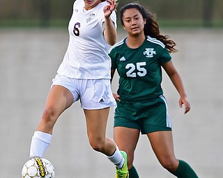 YOUNGSTOWN, OHIO - SEPTEMBER 5, 2018: Boardman's Anna Deeley kicks the ball away from Ursuline's Sering Limbu during the second half of their game on Wednesday night at the Youngstown State soccer complex. DAVID DERMER | THE VINDICATOR