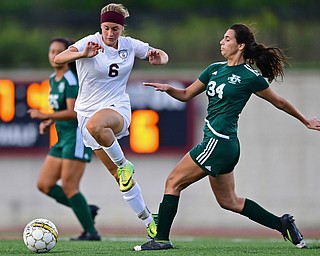 YOUNGSTOWN, OHIO - SEPTEMBER 5, 2018: Boardman's Anna Deeley jumps over Ursuline's Lucia Rohrbaugh while dribbling upfield during the second half of their game on Wednesday night at the Youngstown State soccer complex. DAVID DERMER | THE VINDICATOR