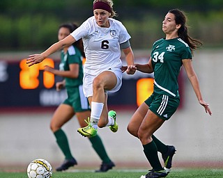 YOUNGSTOWN, OHIO - SEPTEMBER 5, 2018: Boardman's Anna Deeley jumps over Ursuline's Lucia Rohrbaugh while dribbling upfield during the second half of their game on Wednesday night at the Youngstown State soccer complex. DAVID DERMER | THE VINDICATOR