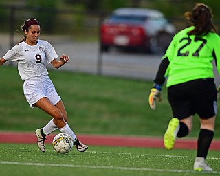 YOUNGSTOWN, OHIO - SEPTEMBER 5, 2018: Boardman's Isabella Alvarico dribbles toward the net while Ursiline goalie Tanner Schade applies pressure during the second half of their game on Wednesday night at the Youngstown State soccer complex. DAVID DERMER | THE VINDICATOR