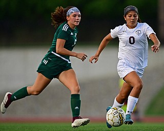 YOUNGSTOWN, OHIO - SEPTEMBER 5, 2018: Boardman's Serene Khatib dribbles ahead of Ursuline's Kenzie Larch during the second half of their game on Wednesday night at the Youngstown State soccer complex. DAVID DERMER | THE VINDICATOR