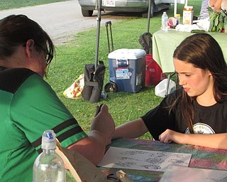 Neighbors | Submitted.A member of the LAOH drew historical Irish sybols on those who were interested at the Heritage Day event during the Austintown Farmers Market.