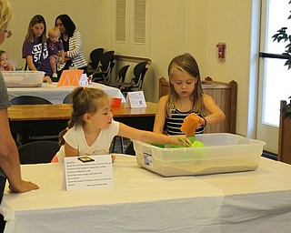 Neighbors | Jessica Harker.Leah Ordean and Eden Gabrick worked together at one of the stations during the Getting Ready for Kindergarten event on Aug. 8 at the Austintown library.