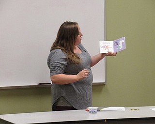 Neighbors | Jessica Harker.Parks employee Cody Stall read "Dinosaur Dance," to the children gathered at the Sprout Club event August 16.