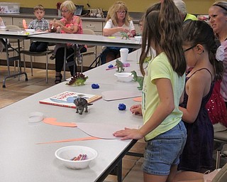 Neighbors | Jessica Harker.Children created paper dinosaurs they could take home at the Sprout Club event August 16 at the Fellows Riverside Garden.