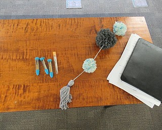Neighbors | Jessica Harker .The finished project created by librarian Missy Williams was on display during the August 20 pompom door hanger making event at the Poland branch.