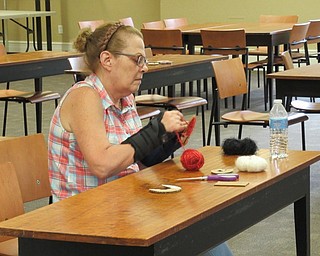 Neighbors | Jessica Harker.Sue Moderalli makes a pompom during the crafting project at the Poland library August 20.