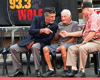 From left, Charles Jaros, a U.S. Army veteran of Vietnam, speaks to James Kenneally, a U.S.M.C veteran of Korea, and Roy Gallatin, a U.S.M.C veteran of World War ||, as Kenneally and Gallatin shake hands at the Austintown Patriot Day ceremony outside of Quaker Steak and Lube in Austintown on Thursday. EMILY MATTHEWS | THE VINDICATOR