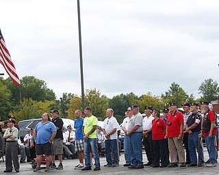 Veterans in the crowd stand while the Austintown Fitch High School concert choir sings at the Austintown Patriot Day ceremony outside of Quaker Steak and Lube in Austintown on Thursday. EMILY MATTHEWS | THE VINDICATOR