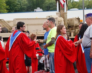 The Austintown Fitch High School concert choir shakes hands with veterans in the crowd at the Austintown Patriot Day ceremony outside of Quaker Steak and Lube in Austintown on Thursday. EMILY MATTHEWS | THE VINDICATOR