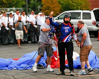 Jimmy Drummond, of Youngstown, lands after skydiving at the Austintown Patriot Day ceremony outside of Quaker Steak and Lube in Austintown on Thursday. EMILY MATTHEWS | THE VINDICATOR