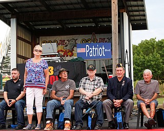 Kathy Tuomala, a U.S Army veteran of Iraq, Afghanistan, Desert Storm, and Iraqi Freedom, stands as she is honored with 12 other veterans at the Austintown Patriot Day ceremony outside of Quaker Steak and Lube in Austintown on Thursday. EMILY MATTHEWS | THE VINDICATOR