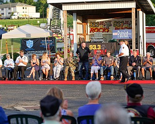 Jason Cottrill, a U.S Air Force veteran of Iraq, Afghanistan, Desert Storm, and Iraqi Freedom, stands as he is honored with 12 other veterans at the Austintown Patriot Day ceremony outside of Quaker Steak and Lube in Austintown on Thursday. EMILY MATTHEWS | THE VINDICATOR