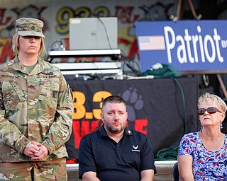 Sgt. First Class Kimberly McGinness, Kathy Tuomala, a U.S Army veteran of Iraq, Afghanistan, Desert Storm, and Iraqi Freedom, stands as she is honored with 12 other veterans, including Jason Cottrill, a U.S Air Force veteran of Iraq, Afghanistan, Desert Storm, and Iraqi Freedom, center, and Kathy Tuomala, a U.S Army veteran of Iraq, Afghanistan, Desert Storm, and Iraqi Freedom, right, at the Austintown Patriot Day ceremony outside of Quaker Steak and Lube in Austintown on Thursday. EMILY MATTHEWS | THE VINDICATOR