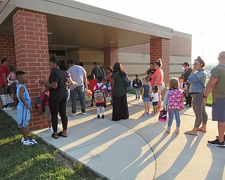 Neighbors | Jessica Harker.Children and their guardians waited outside of Austintown Elementary School on Aug. 28 to enter and start the first day of the new year.