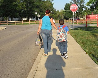 Neighbors | Jessica Harker.Children walk into Austintown Elementary School on Aug. 28 for the first day of classes for the Austintown school district.