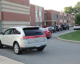 Neighbors | Jessica Harker.Cars lined the side walk up to Austintown Elementary School as students were dropped off for their first day of classes.