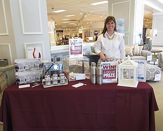 Neighbors | Jessica Harker.Carlye Cebach, a Levin Furniture employee, ran the table where attendees of the grand opening ceremony were able to enter to win a number of door prizes, as well as a $5,000 shopping spree.