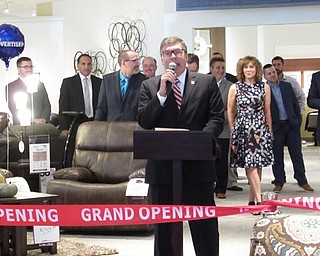 Neighbors | Jessica Harker.Levin Furniture employee John Cline spoke during the grand opening ceremony August 31 at the new location on Boardman-Poland road.