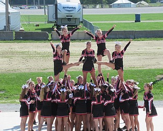 Neighbors | Jessica Harker.Five girls were held up by other members of the Canfield Cheerleading Squad during their performance at the Canfield Fair August 29.
