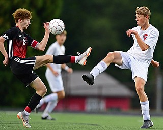 CANFIELD, OHIO - SEPTEMBER 6, 2018: Canfield's Hunter Hale, left, and Fitch's Marcus Debaldo battle for the ball during the first half of their game, Thursday night at Canfield High School. DAVID DERMER | THE VINDICATOR