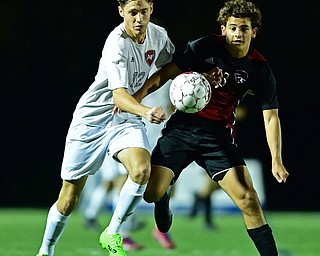 CANFIELD, OHIO - SEPTEMBER 6, 2018: Fitch's Alex Sorrells and Canfield's Mike Mecure battle for the ball during the first half of their game, Thursday night at Canfield High School. DAVID DERMER | THE VINDICATOR