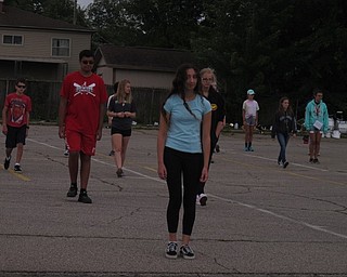 Neighbors | Jessica Harker.Amani Wadi-Ramahi marched in the front of a group of students practicing drills during the 2018 Austintown band camp.