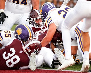 Boardman tackles Jackson and attempts to take possession of the ball during the first half of their game Friday night at Boardman. EMILY MATTHEWS | THE VINDICATOR