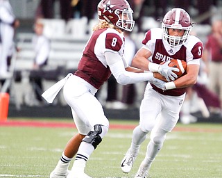 Boardman's Mike Ohoro (8) hands the ball off to Josh Rodriguez during the first half of their against Jackson game Friday night at Boardman. EMILY MATTHEWS | THE VINDICATOR