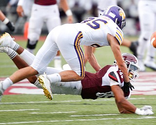 Boardman's Aidan Slocum misses the ball as Jackson's Preston Johnson tackles him during the first half of their game Friday night at Boardman. EMILY MATTHEWS | THE VINDICATOR