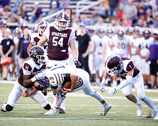 Boardman's Che Trevena (11) and Mike Fesko (1) go after Jackson's Trey Wright during the first half of their game Friday night at Boardman. EMILY MATTHEWS | THE VINDICATOR