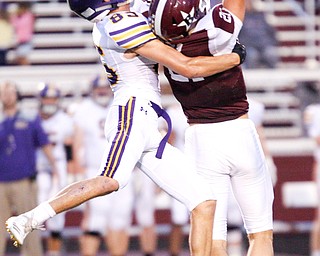 Boardman's Cam Kreps misses the ball as he's tackled by Jackson's Preston Johnson during the first half of their game Friday night at Boardman. EMILY MATTHEWS | THE VINDICATOR