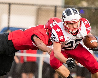 DIANNA OATRIDGE | THE VINDICATOR  Niles' Travis Molnar (22) tries to avoid a tackle by Struthers' Tyrese Hawkins (5) during their game in Struthers on Friday.